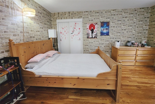 209-2018th Ave 5E, Bayside, NY 11360 - bedroom with wood finished floors and brick wall