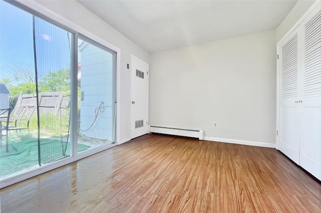 4 Red Barn Ln, Middletown, NY 10940 - unfurnished bedroom with baseboard heating, light wood finished floors, access to outside, and baseboards