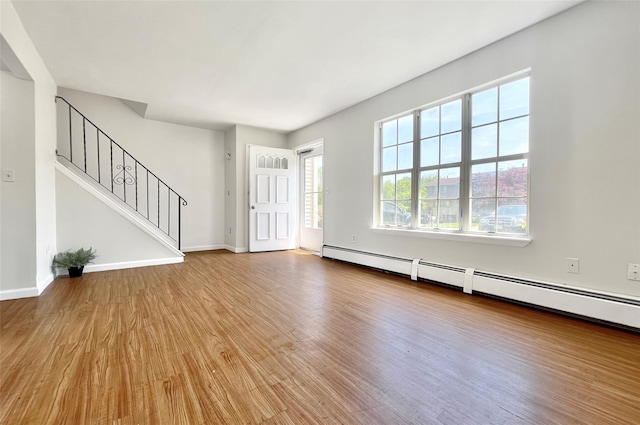 4 Red Barn Ln, Middletown, NY 10940 - entrance foyer with wood finished floors, stairway, baseboards, and a baseboard heating unit
