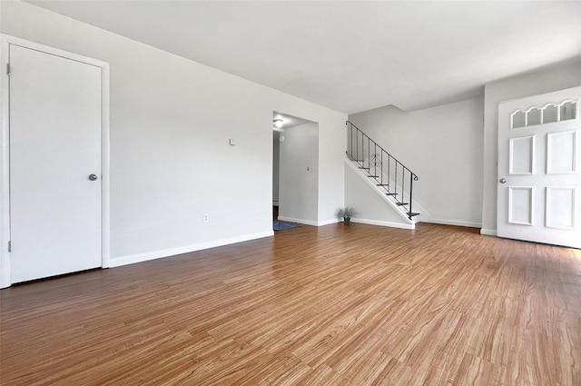 4 Red Barn Ln, Middletown, NY 10940 - unfurnished living room with stairway, wood finished floors, and baseboards