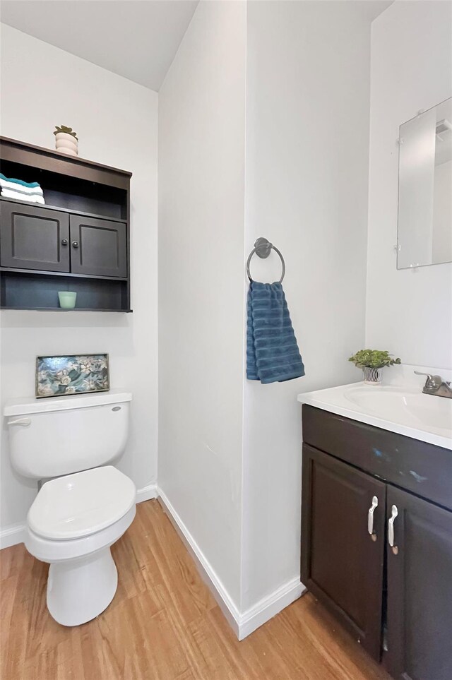 4 Red Barn Ln, Middletown, NY 10940 - bathroom featuring wood finished floors, vanity, baseboards, and toilet