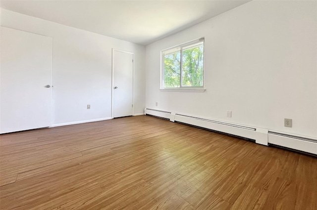 4 Red Barn Ln, Middletown, NY 10940 - empty room with wood finished floors, baseboard heating, and baseboards