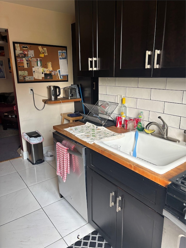 61 Bronx River Rd Unit 8E, Yonkers, NY 10704 - kitchen with butcher block counters, backsplash, a sink, dark cabinets, and stainless steel dishwasher