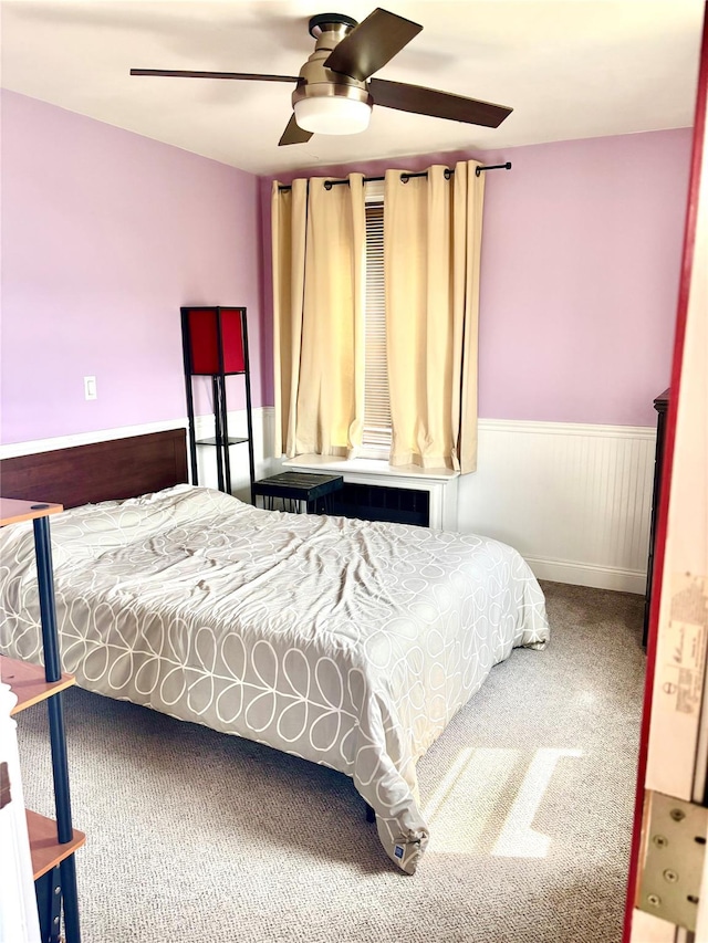 61 Bronx River Rd Unit 8E, Yonkers, NY 10704 - bedroom featuring carpet floors, a wainscoted wall, and a ceiling fan