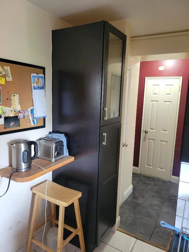 61 Bronx River Rd Unit 8E, Yonkers, NY 10704 - kitchen featuring tile patterned flooring and glass insert cabinets