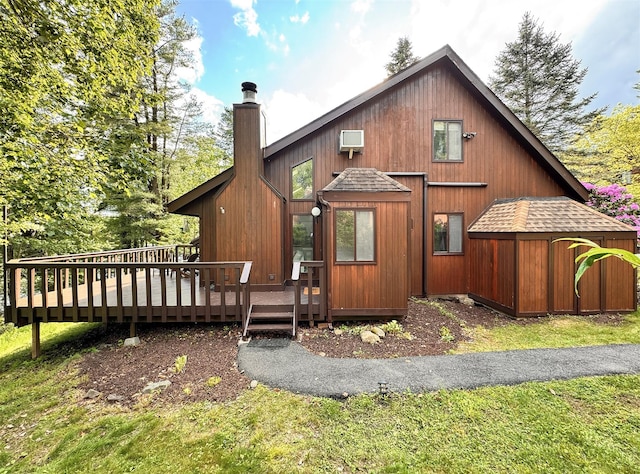 24 Lakeview Ter, Monticello, NY 12701 - view of front of house featuring a shingled roof, a chimney, a deck, and a shed
