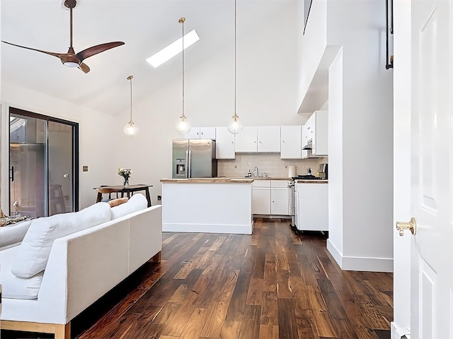 24 Lakeview Ter, Monticello, NY 12701 - kitchen with stainless steel fridge with ice dispenser, white range with gas stovetop, dark wood-type flooring, high vaulted ceiling, and a ceiling fan