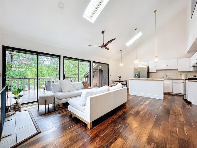 24 Lakeview Ter, Monticello, NY 12701 - living area with a skylight, healthy amount of natural light, dark wood finished floors, high vaulted ceiling, and ceiling fan