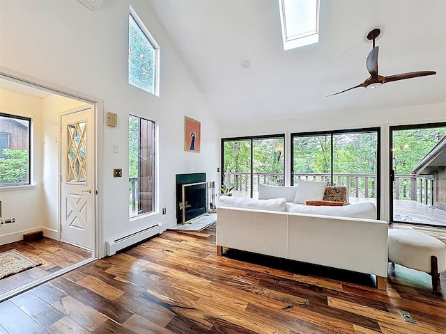 24 Lakeview Ter, Monticello, NY 12701 - living area with baseboard heating, a skylight, high vaulted ceiling, wood finished floors, and ceiling fan