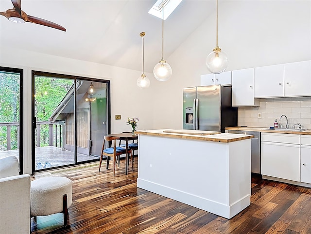 24 Lakeview Ter, Monticello, NY 12701 - kitchen with stainless steel fridge with ice dispenser, white cabinets, backsplash, dark wood finished floors, and a skylight