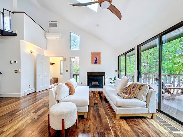 24 Lakeview Ter, Monticello, NY 12701 - living area with high vaulted ceiling, wood-type flooring, a wall mounted air conditioner, a ceiling fan, and a fireplace