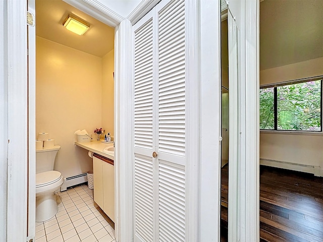 24 Lakeview Ter, Monticello, NY 12701 - half bathroom with baseboard heating, tile patterned flooring, and vanity