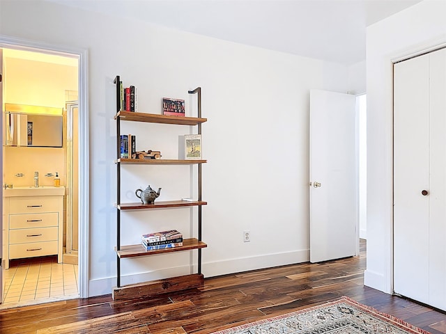 24 Lakeview Ter, Monticello, NY 12701 - unfurnished bedroom with wood finished floors, connected bathroom, and a closet