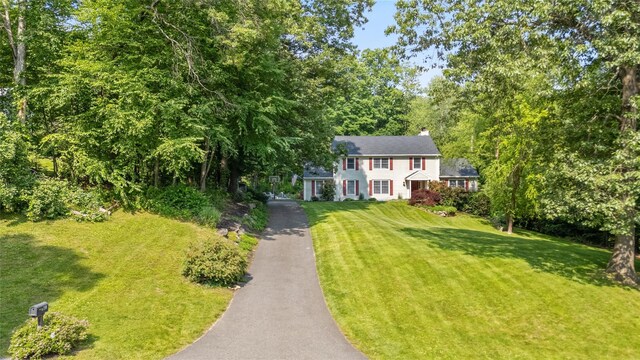 41 Indian Hill Rd, Brewster, NY 10509 - colonial-style house with asphalt driveway, a front lawn, and a chimney