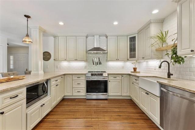 41 Indian Hill Rd, Brewster, NY 10509 - kitchen featuring stainless steel appliances, wall chimney range hood, light stone countertops, tasteful backsplash, and recessed lighting
