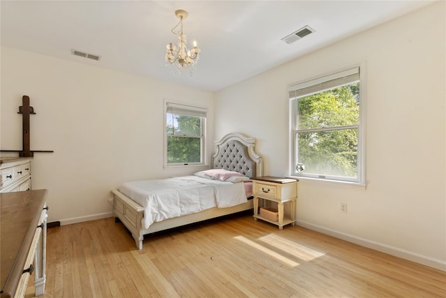 41 Indian Hill Rd, Brewster, NY 10509 - bedroom featuring light wood-style floors, multiple windows, and a chandelier