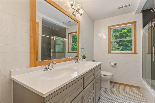41 Indian Hill Rd, Brewster, NY 10509 - bathroom featuring tile walls, double vanity, and shower / bath combination with glass door