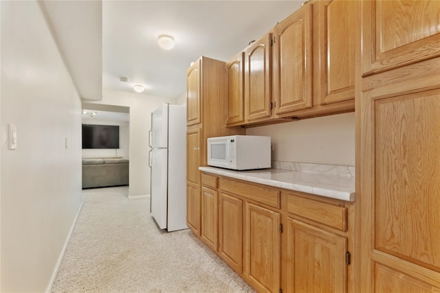 41 Indian Hill Rd, Brewster, NY 10509 - kitchen with white appliances, light colored carpet, and tile counters