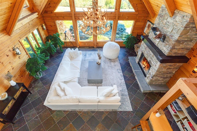 53 Vista Ln, Port Jervis, NY 12771 - living room with wood walls, healthy amount of natural light, stone tile floors, a chandelier, and high vaulted ceiling