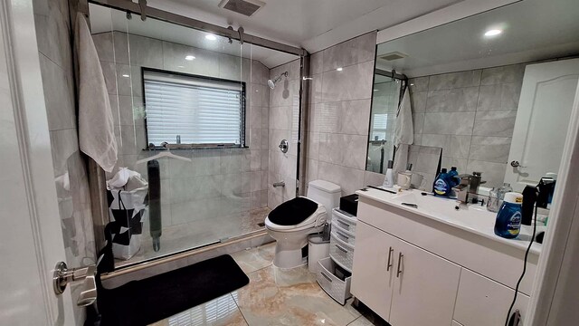 32-37 214th Sts, Bayside, NY 11361 - full bathroom with tile walls, a shower stall, vanity, and recessed lighting