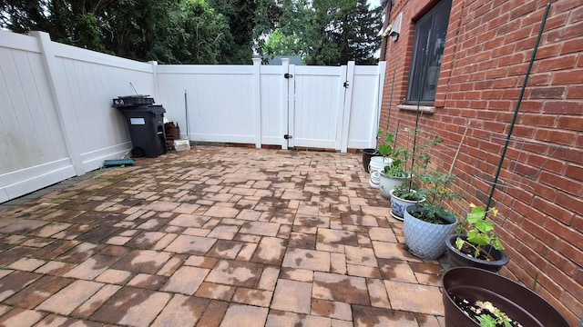 32-37 214th Sts, Bayside, NY 11361 - fenced backyard featuring a gate and a patio