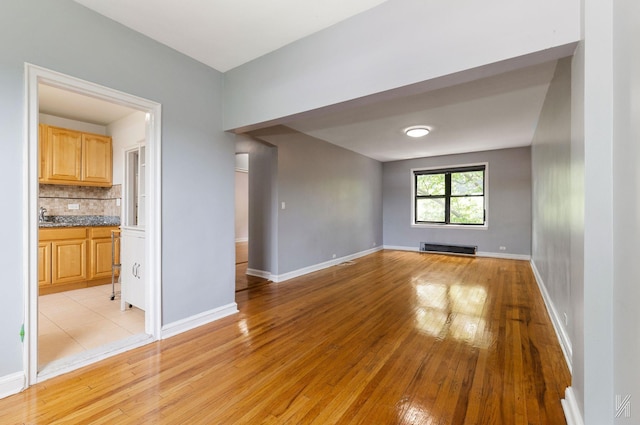 22-20 76th St Unit C3, East Elmhurst, NY 11370 - spare room with light wood-style flooring and baseboards