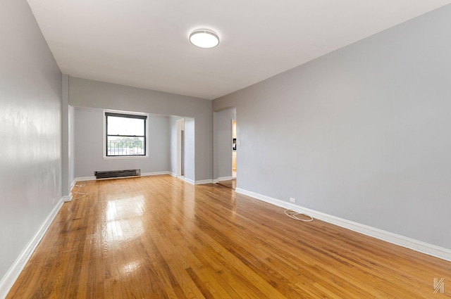 22-20 76th St Unit C3, East Elmhurst, NY 11370 - unfurnished room with light wood-type flooring, baseboards, and a baseboard radiator
