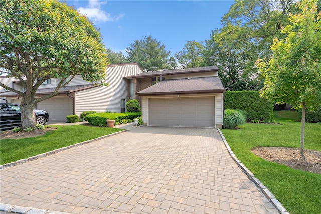 55 Maple Run Dr, Jericho, NY 11753 - view of front facade featuring decorative driveway, a front yard, and an attached garage