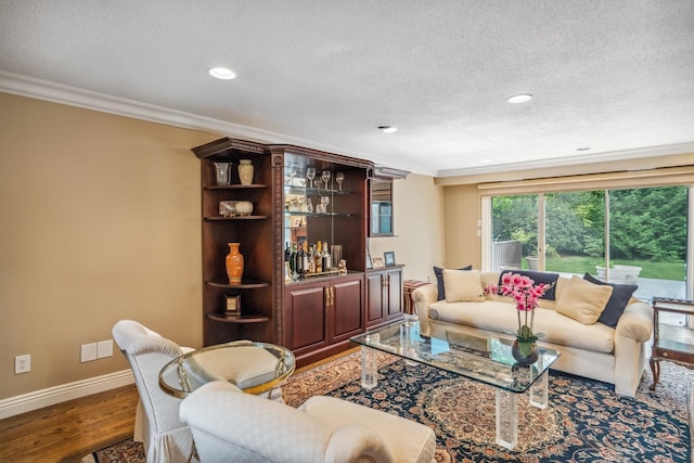 55 Maple Run Dr, Jericho, NY 11753 - living room with ornamental molding, wood finished floors, a textured ceiling, recessed lighting, and bar area