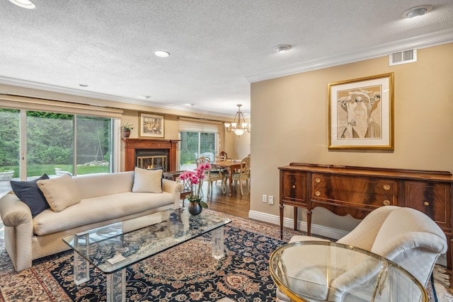 55 Maple Run Dr, Jericho, NY 11753 - living room with ornamental molding, a textured ceiling, a chandelier, wood finished floors, and recessed lighting