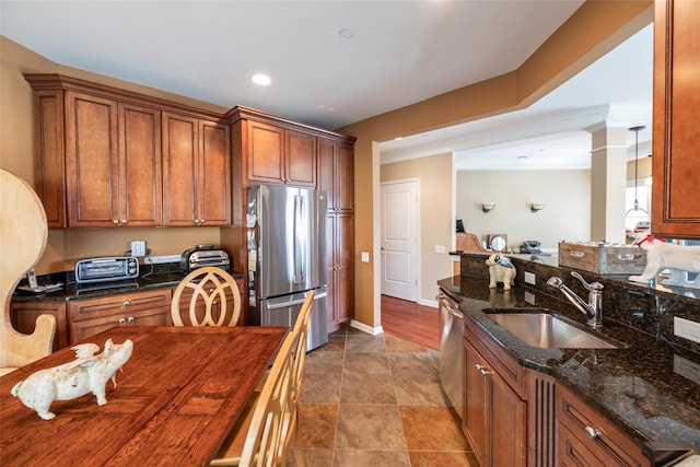 77 Maple Ave Unit 101, Rockville Centre, NY 11570 - kitchen with stainless steel appliances, a sink, brown cabinets, dark stone counters, and recessed lighting