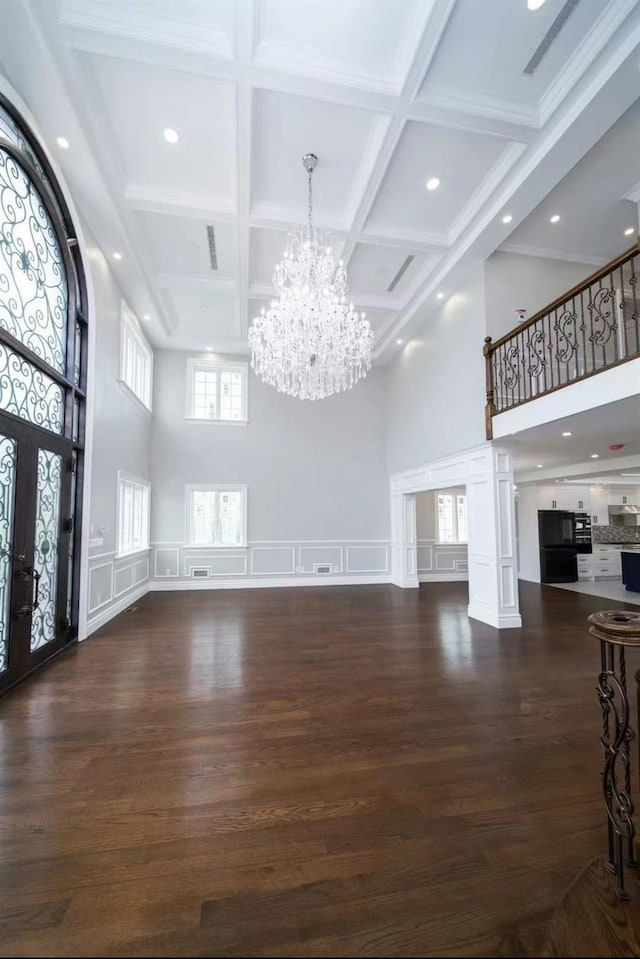 24-11 157th St, Whitestone, NY 11357 - entrance foyer featuring a high ceiling, a chandelier, beam ceiling, a decorative wall, and wood finished floors