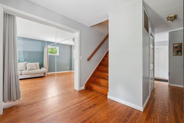 484 N Magee St, Southampton, NY 11968 - stairway featuring wood finished floors and baseboards