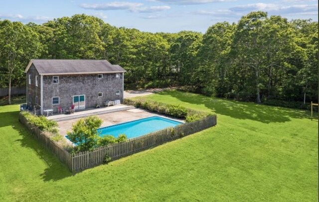 484 N Magee St, Southampton, NY 11968 - view of pool featuring an outbuilding, a view of trees, a patio, and an exterior structure