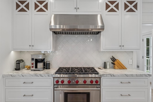 41 Landing Ln, East Quogue, NY 11942 - kitchen featuring under cabinet range hood, high end stove, white cabinets, and backsplash