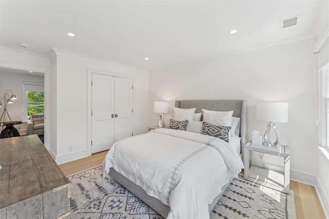 41 Landing Ln, East Quogue, NY 11942 - bedroom with ornamental molding, light wood finished floors, baseboards, recessed lighting, and a closet