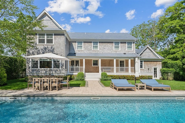 41 Landing Ln, East Quogue, NY 11942 - back of property with a patio, an outdoor pool, and outdoor dining area
