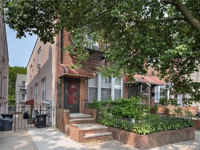 1840 21st Dr, Astoria, NY 11105 - view of front facade with brick siding and a gate