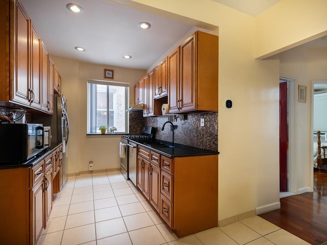 1840 21st Dr, Astoria, NY 11105 - kitchen featuring a sink, stainless steel appliances, dark countertops, decorative backsplash, and recessed lighting
