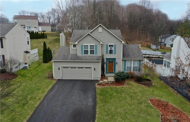 18 Chaucer Cir, Baldwinsville, NY 13027 - traditional-style home featuring asphalt driveway, a front yard, and a chimney