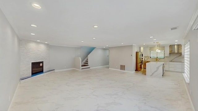 14 Acorn Ponds Dr Unit 14, Roslyn, NY 11576 - unfurnished living room featuring ornamental molding, recessed lighting, baseboards, light marble finish flooring, and stairway