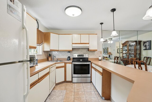 34 Overlook Commons, Yorktown Heights, NY 10598 - kitchen with white appliances, under cabinet range hood, decorative backsplash, light countertops, and a ceiling fan