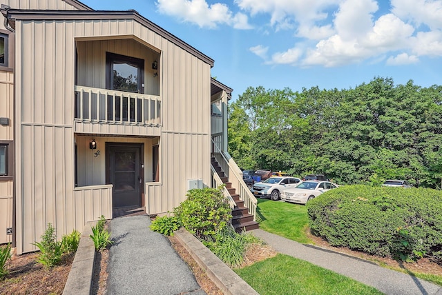 34 Overlook Commons, Yorktown Heights, NY 10598 - view of front of property with board and batten siding, a balcony, and stairs