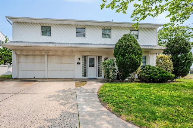 3929 Greentree Dr, Oceanside, NY 11572 - view of front of home featuring a garage, driveway, and a front yard