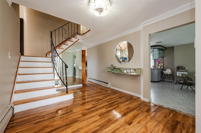 3929 Greentree Dr, Oceanside, NY 11572 - stairs with a baseboard heating unit, wood finished floors, baseboards, crown molding, and a chandelier