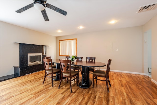 3929 Greentree Dr, Oceanside, NY 11572 - dining room featuring wood finished floors, baseboards, a ceiling fan, recessed lighting, and a premium fireplace