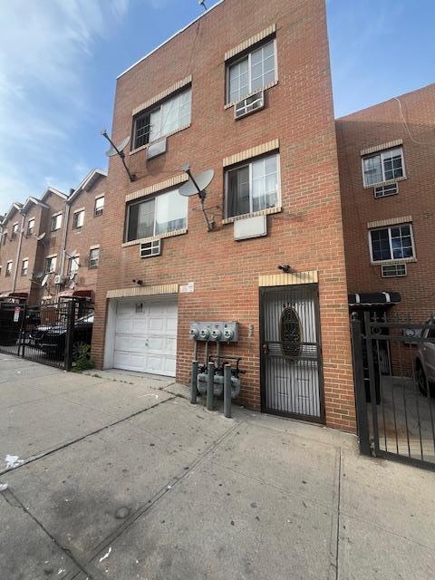 879 Elsmere Pl, Bronx, NY 10460 - view of property featuring driveway and an attached garage