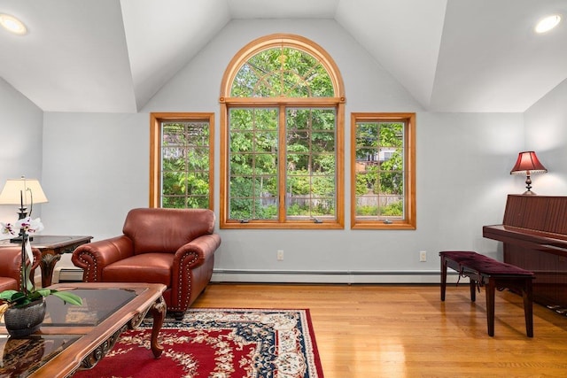 25 Glacier Dr, Smithtown, NY 11787 - living area with lofted ceiling, wood finished floors, and baseboard heating