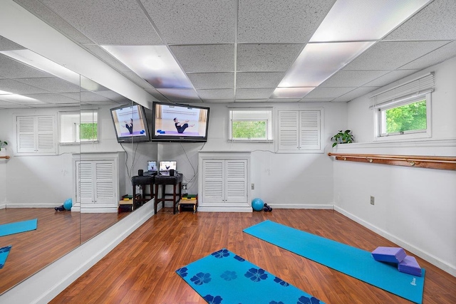 25 Glacier Dr, Smithtown, NY 11787 - exercise room featuring a drop ceiling, baseboards, and wood finished floors