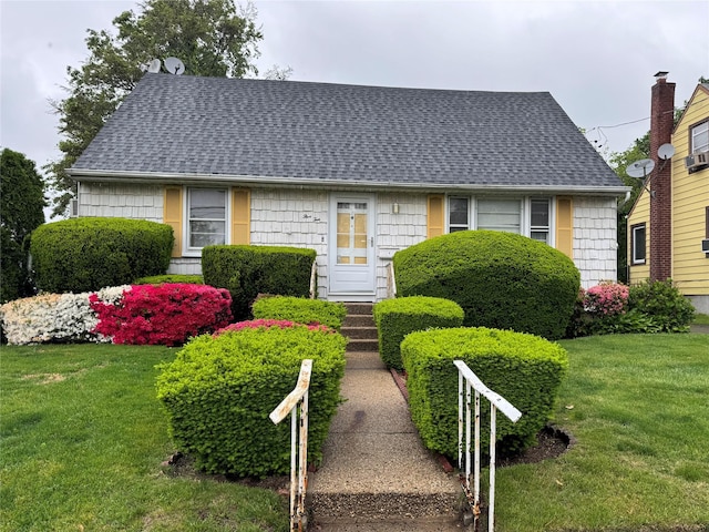 510 7th St, West Hempstead, NY 11552 - cape cod home featuring roof with shingles and a front yard